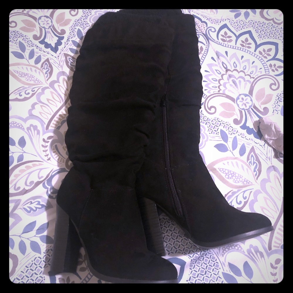 Black knee boots. Never worn.